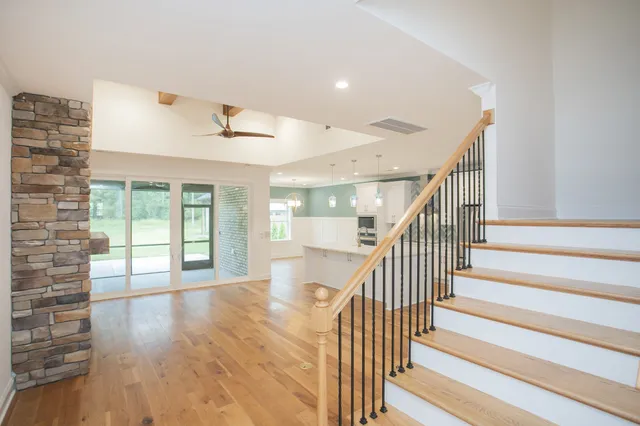 a view of entryway and hall with wooden floor