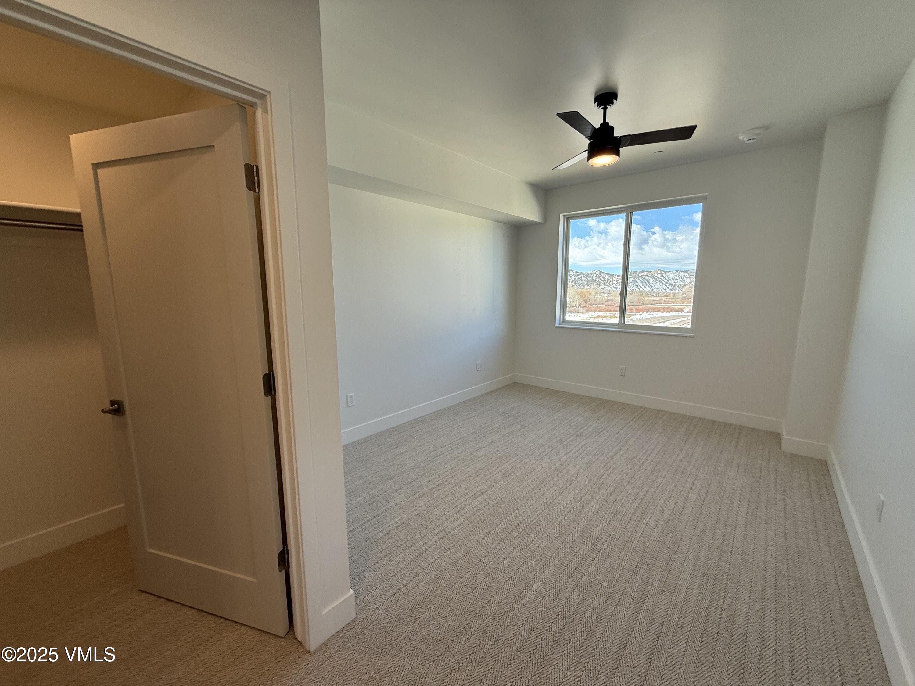 91 Mount Hope Circle, Unit G301 Eagle, CO 81631 - Photo 8 of 13 a view of room with window and ceiling fan