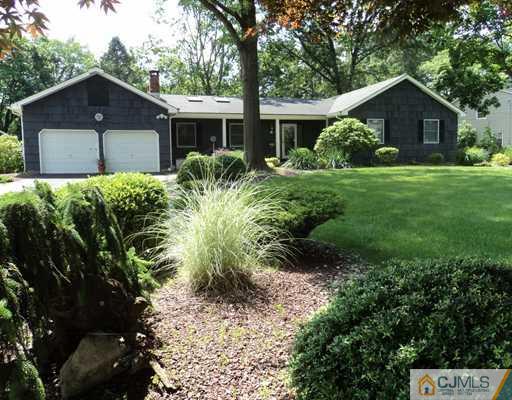 17 Woodlot Road East Brunswick, NJ 08816 - Photo 2 of 25 a front view of a house with a yard and potted plants