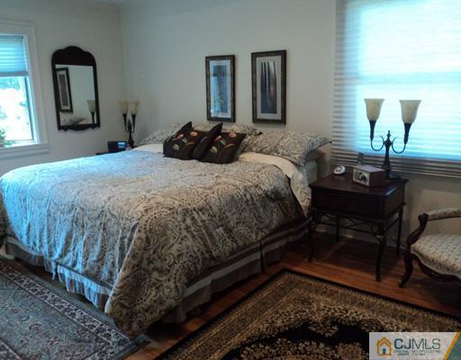17 Woodlot Road East Brunswick, NJ 08816 - Photo 13 of 25 a bedroom with a bed a mirror and lamp