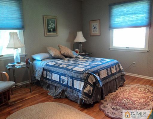 17 Woodlot Road East Brunswick, NJ 08816 - Photo 17 of 25 a bedroom with a bed table and window