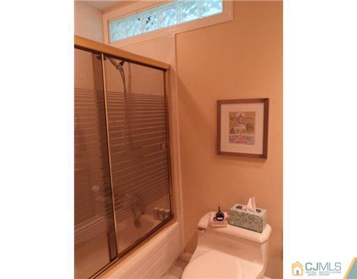17 Woodlot Road East Brunswick, NJ 08816 - Photo 20 of 25 a bathroom with a bathtub