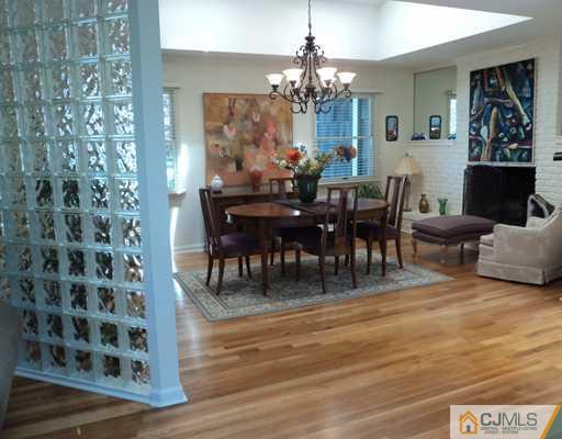 17 Woodlot Road East Brunswick, NJ 08816 - Photo 3 of 25 a view of a dining room with furniture and chandelier
