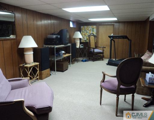 17 Woodlot Road East Brunswick, NJ 08816 - Photo 22 of 25 a living room with furniture a lamp and a window