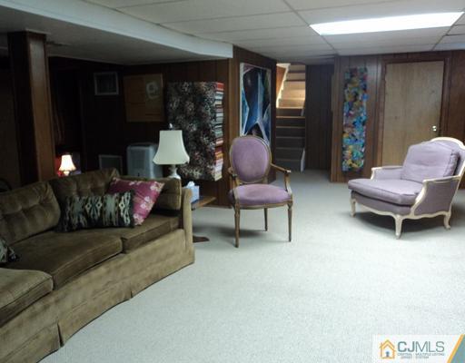 17 Woodlot Road East Brunswick, NJ 08816 - Photo 23 of 25 a living room with furniture and a large window