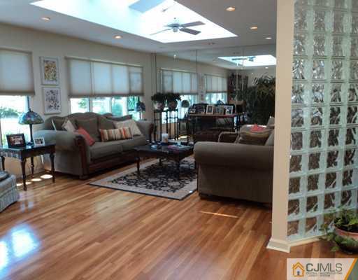 17 Woodlot Road East Brunswick, NJ 08816 - Photo 5 of 25 a living room with furniture and a wooden floor