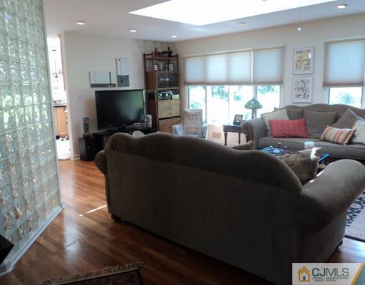 17 Woodlot Road East Brunswick, NJ 08816 - Photo 7 of 25 a living room with furniture and a flat screen tv