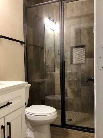 a bathroom with a toilet a sink and shower