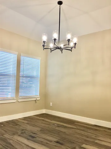 a view of a room with a window and wooden floor