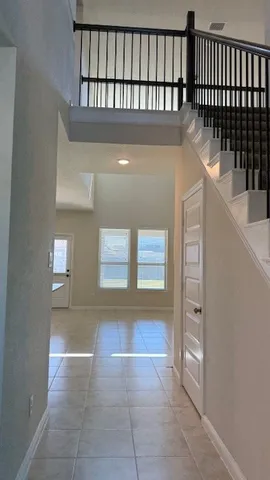 an empty room with a empty space and windows