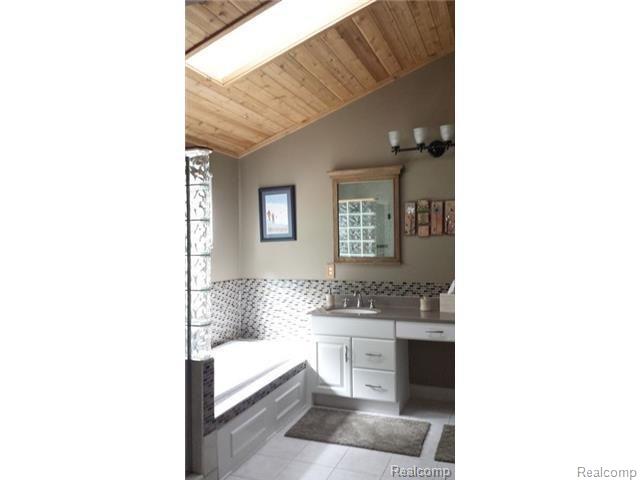 8028 McClements Road Brighton, MI 48114 - Photo 15 of 28 Lots of light in here with wood ceiling and skylight!