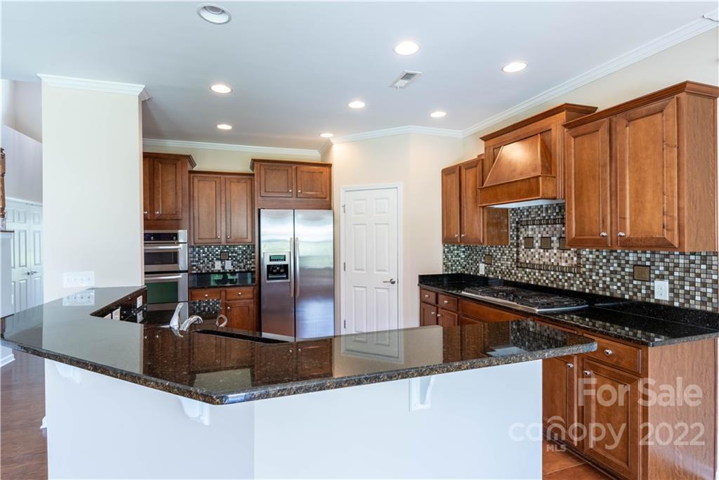 8115 Red Water Road Charlotte, NC 28277 - Photo 14 of 25 a kitchen with stainless steel appliances granite countertop a sink and a counter top space