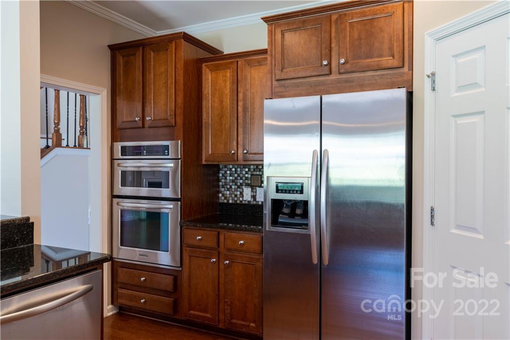 8115 Red Water Road Charlotte, NC 28277 - Photo 15 of 25 a kitchen with granite countertop a refrigerator and a stove