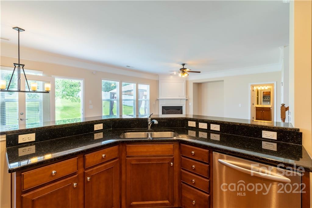 8115 Red Water Road Charlotte, NC 28277 - Photo 17 of 25 a kitchen with granite countertop a sink and a counter top space