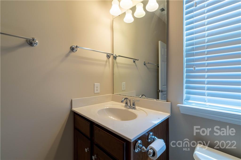 8115 Red Water Road Charlotte, NC 28277 - Photo 19 of 25 a bathroom with a sink a mirror and a window