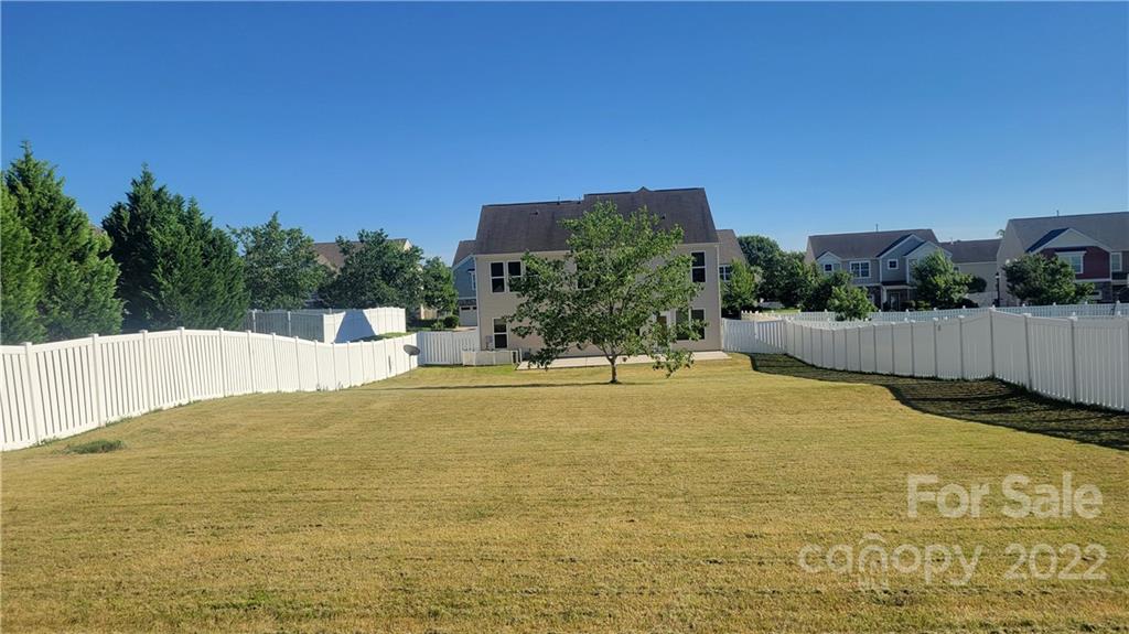 8115 Red Water Road Charlotte, NC 28277 - Photo 5 of 25 a swimming pool with plants and trees in the background