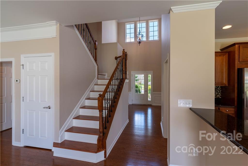 8115 Red Water Road Charlotte, NC 28277 - Photo 8 of 25 a view of a hallway with wooden floor and staircase