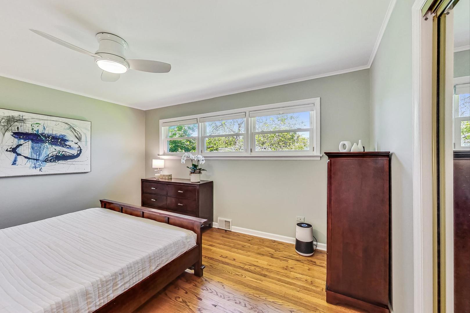 1340 Pendleton Lane Glenview, IL 60025 - Photo 18 of 39 a bedroom with a bed and wooden floor