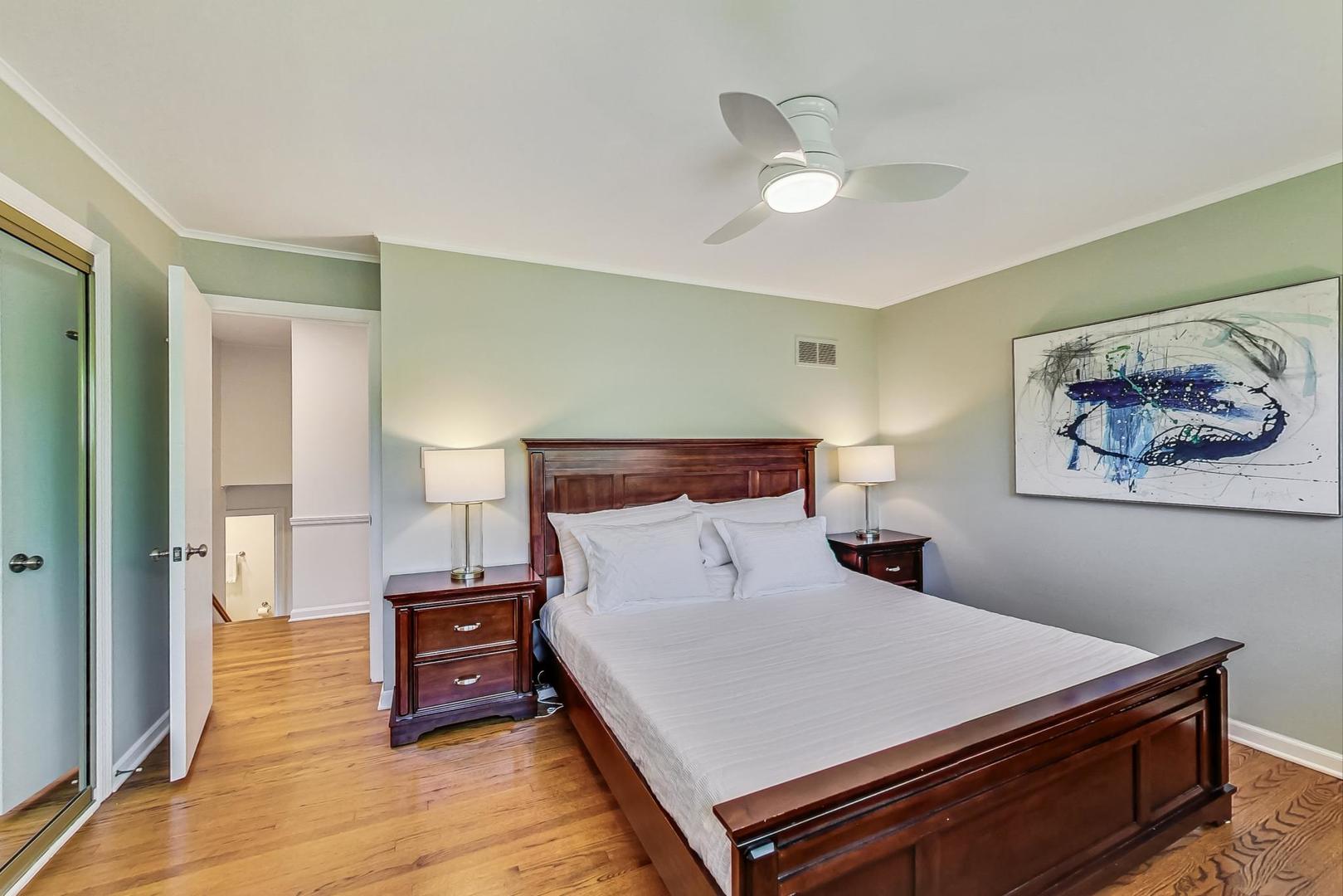 1340 Pendleton Lane Glenview, IL 60025 - Photo 19 of 39 a bedroom with a bed and a painting on the wall