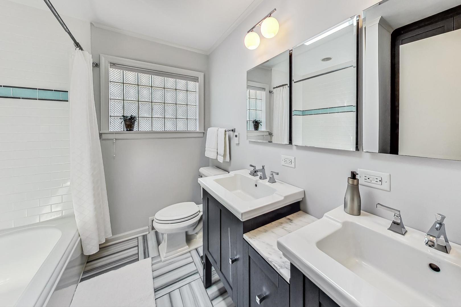 1340 Pendleton Lane Glenview, IL 60025 - Photo 20 of 39 a bathroom with a sink toilet and shower