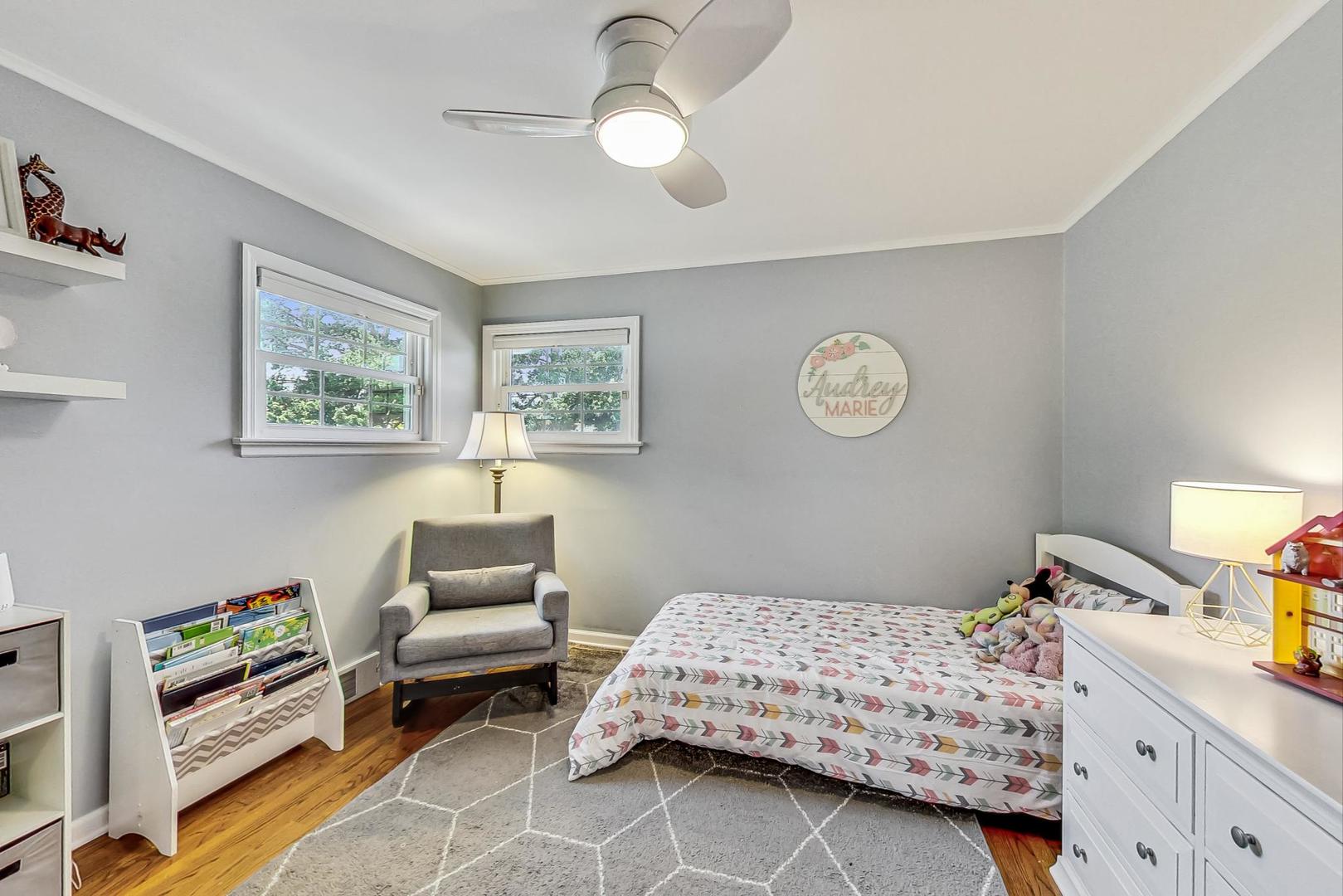 1340 Pendleton Lane Glenview, IL 60025 - Photo 21 of 39 a bedroom with a bed and a chandelier