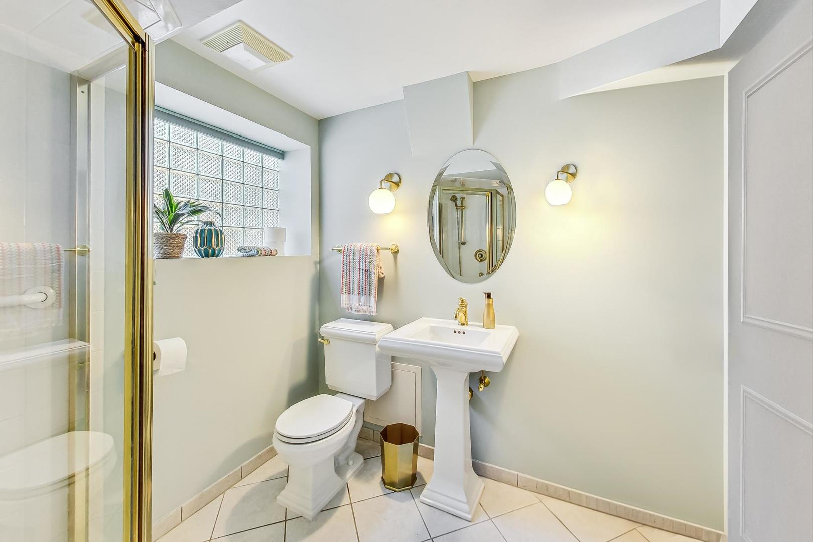 1340 Pendleton Lane Glenview, IL 60025 - Photo 30 of 39 a bathroom with a toilet a sink and a mirror