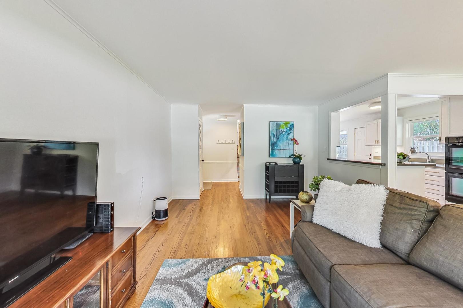 1340 Pendleton Lane Glenview, IL 60025 - Photo 6 of 39 a living room with furniture and a flat screen tv
