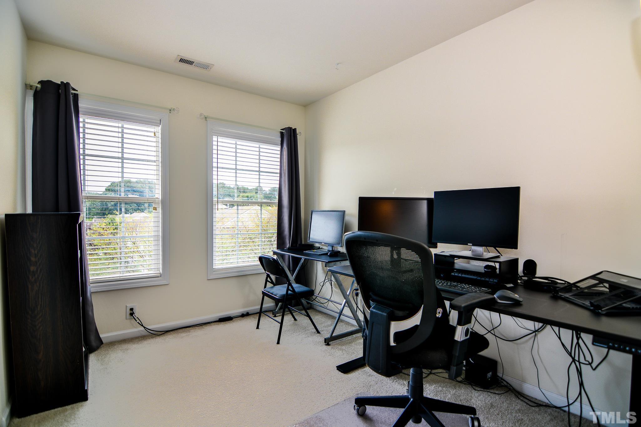 8120 Upper Lake Drive Raleigh, NC 27615 - Photo 16 of 29 a view of a workspace with furniture and a window