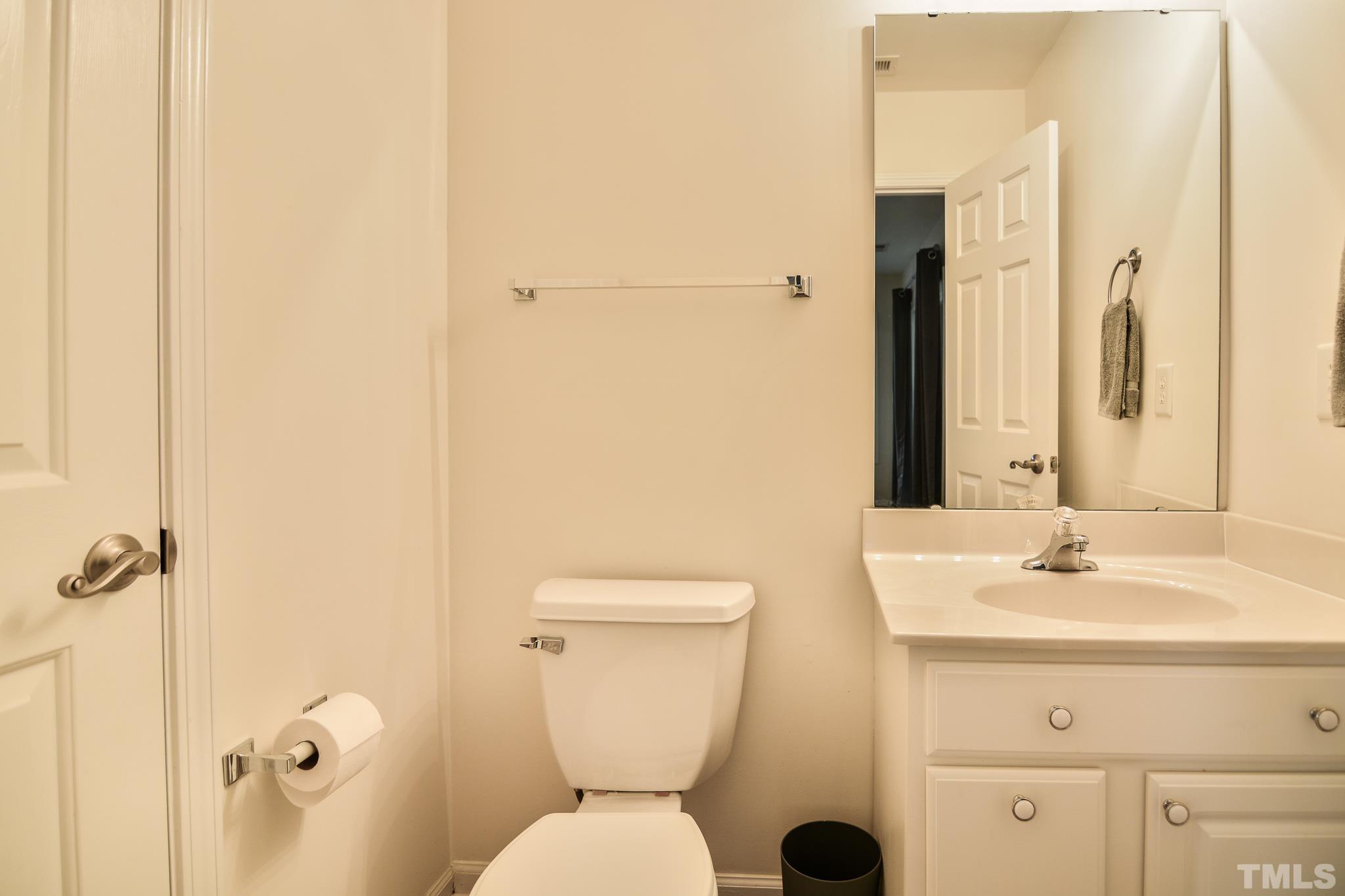 8120 Upper Lake Drive Raleigh, NC 27615 - Photo 22 of 29 a bathroom with a toilet sink and mirror