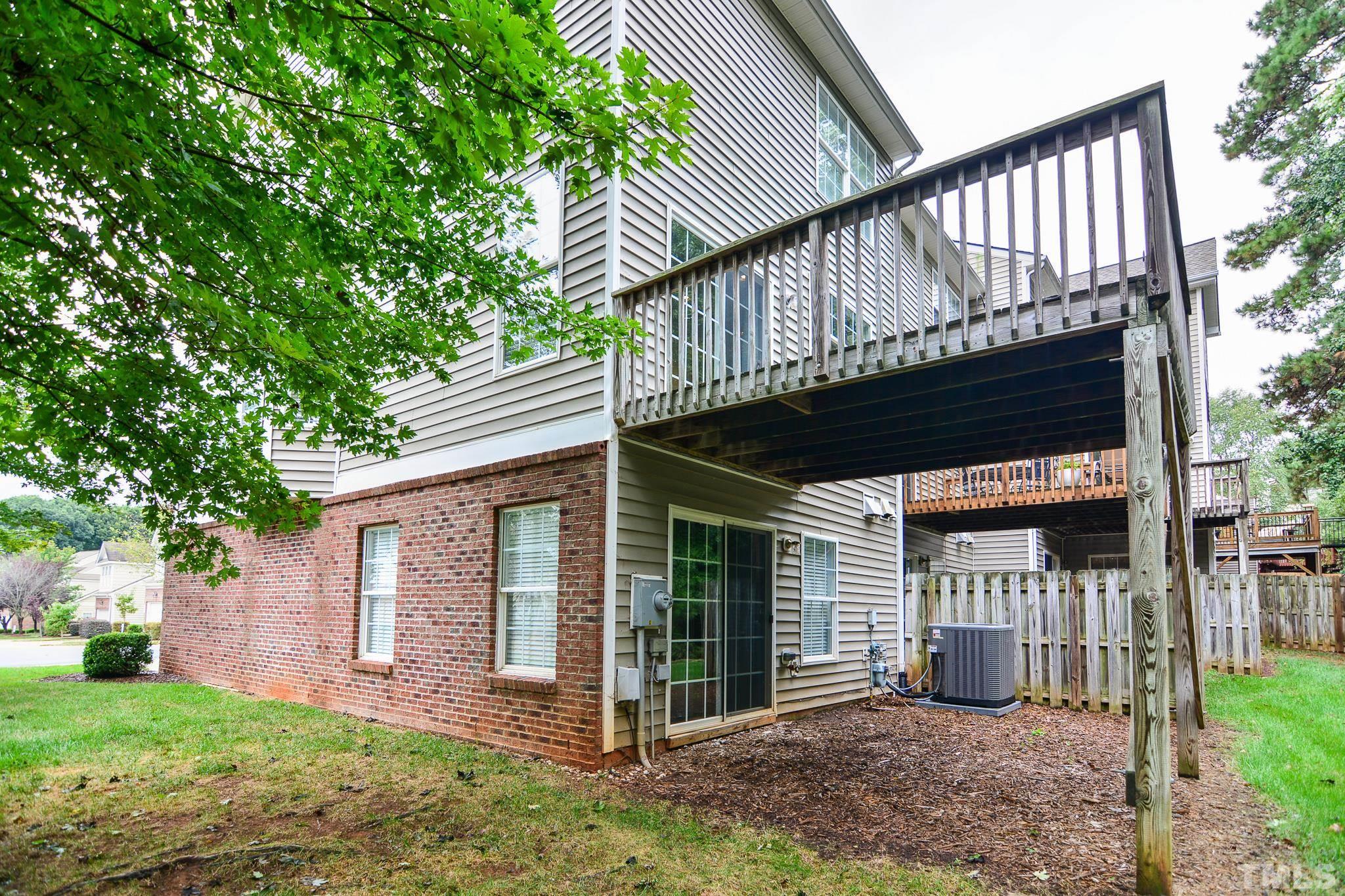 8120 Upper Lake Drive Raleigh, NC 27615 - Photo 25 of 29 a view of a house with a yard balcony and wooden fence