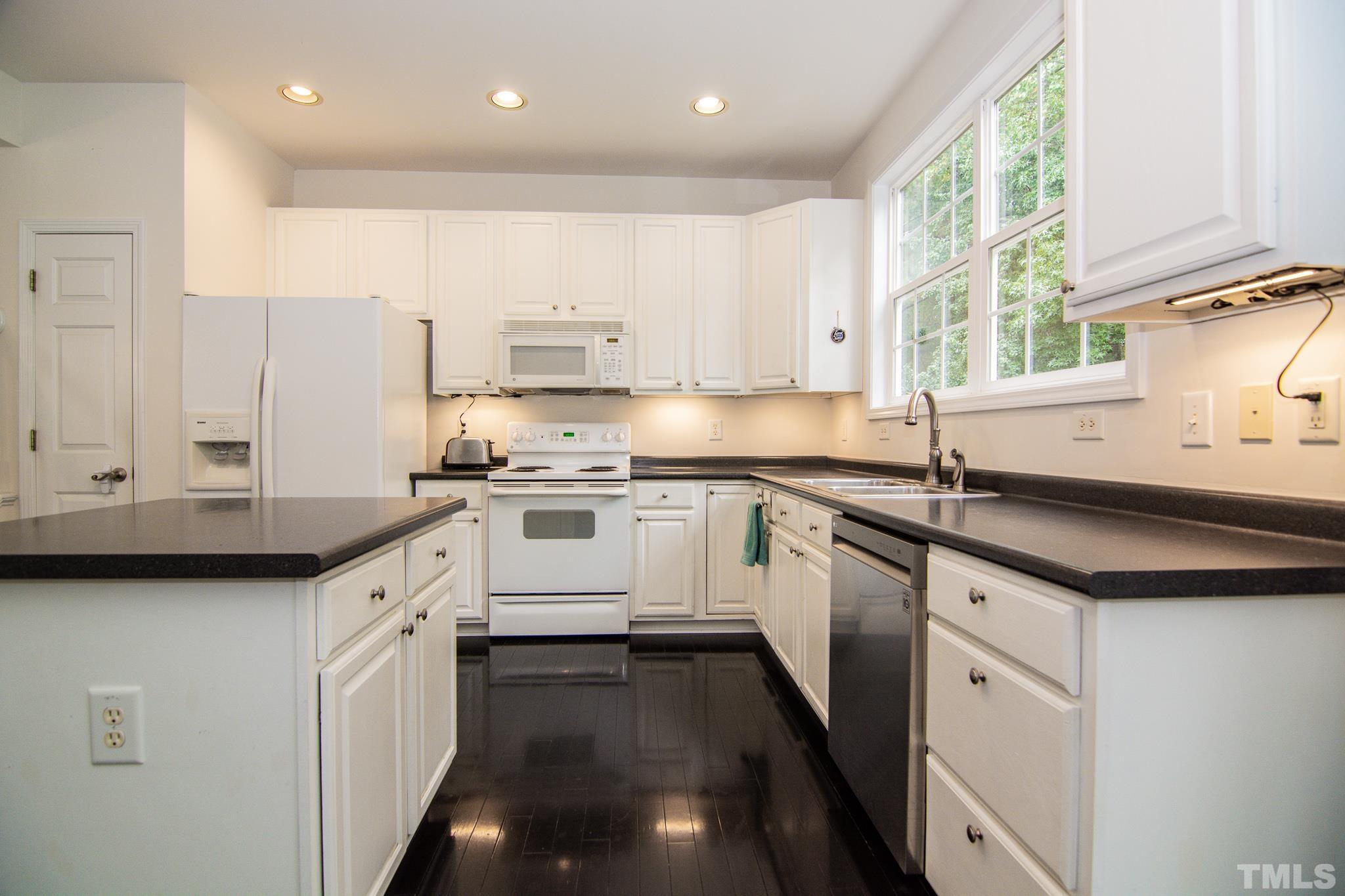 8120 Upper Lake Drive Raleigh, NC 27615 - Photo 4 of 29 a kitchen with stainless steel appliances granite countertop a sink a stove and a refrigerator