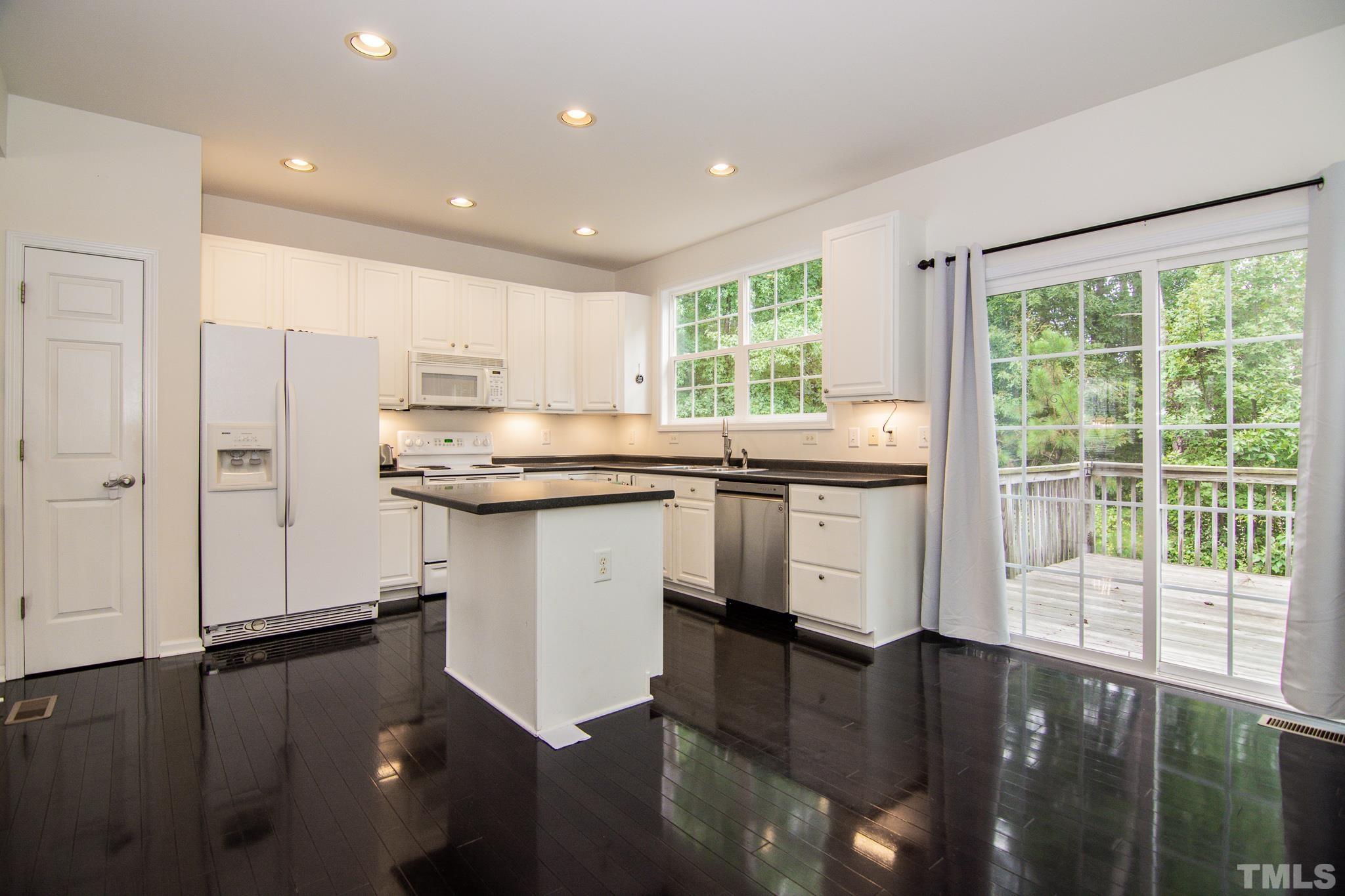 8120 Upper Lake Drive Raleigh, NC 27615 - Photo 7 of 29 a kitchen with stainless steel appliances granite countertop a stove a sink and a microwave