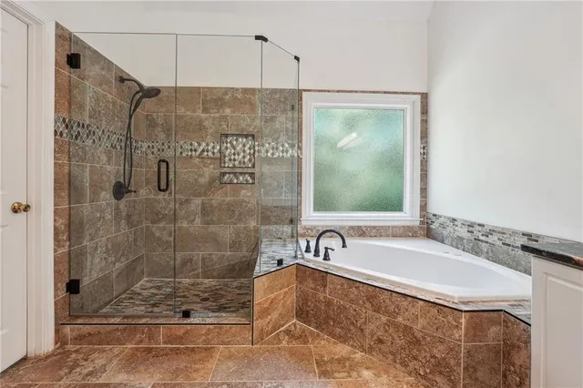 a bathroom with a bathtub and a shower
