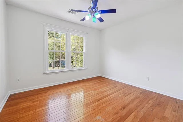 wooden floor in an empty room with a window