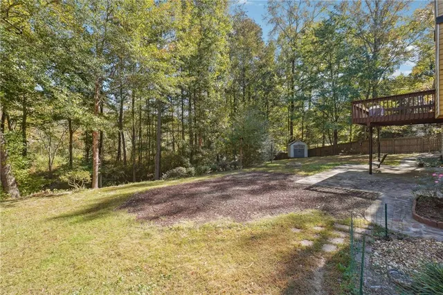 a view of a street with a bench and trees