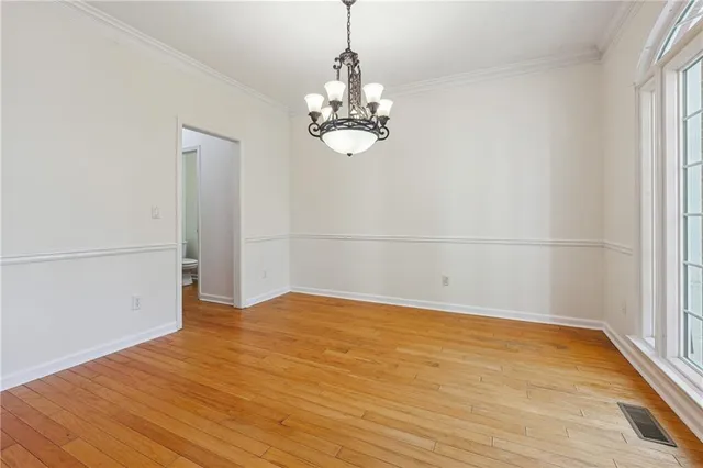 a view of a room with wooden floor and a window