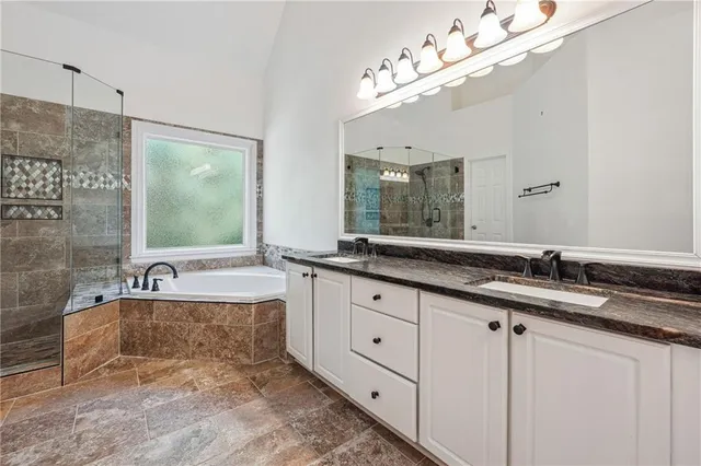 a bathroom with double sink and a mirror