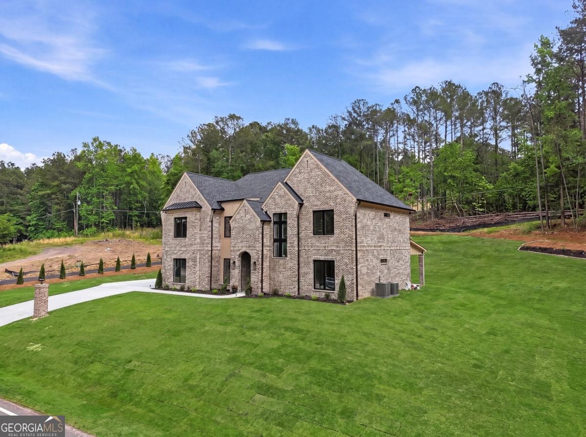 1557 Whitley Road Dacula, GA 30019 - Photo 3 of 46 a front view of a house with garden