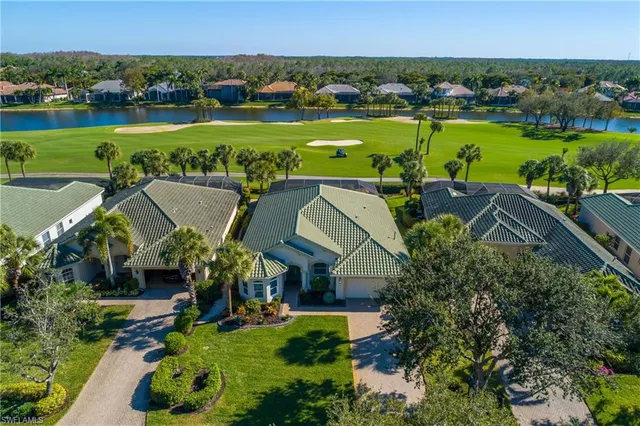 an aerial view of a house with a garden and lake view