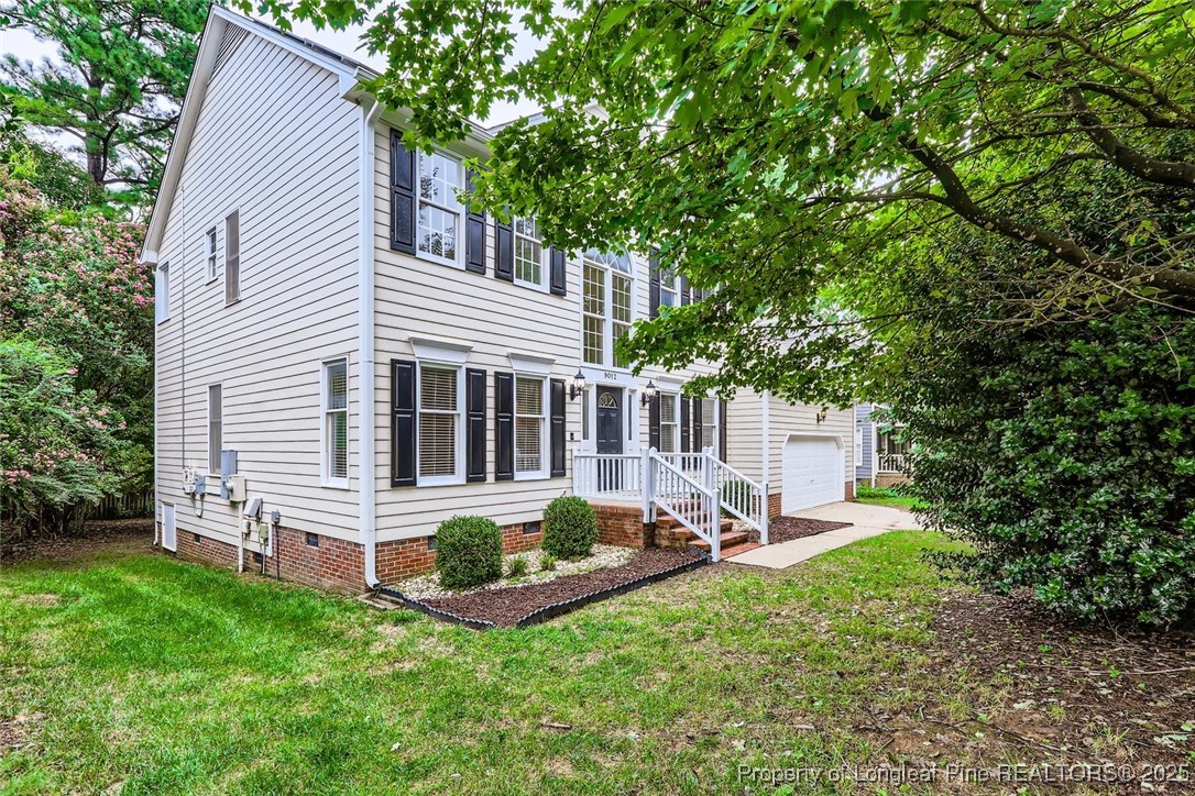 a view of a house with backyard sitting area and garden