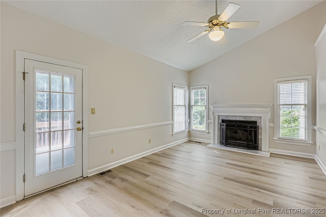 9012 Walking Stick Trail Raleigh, NC 27615 - Photo 12 of 28 an empty room with windows fireplace and fan