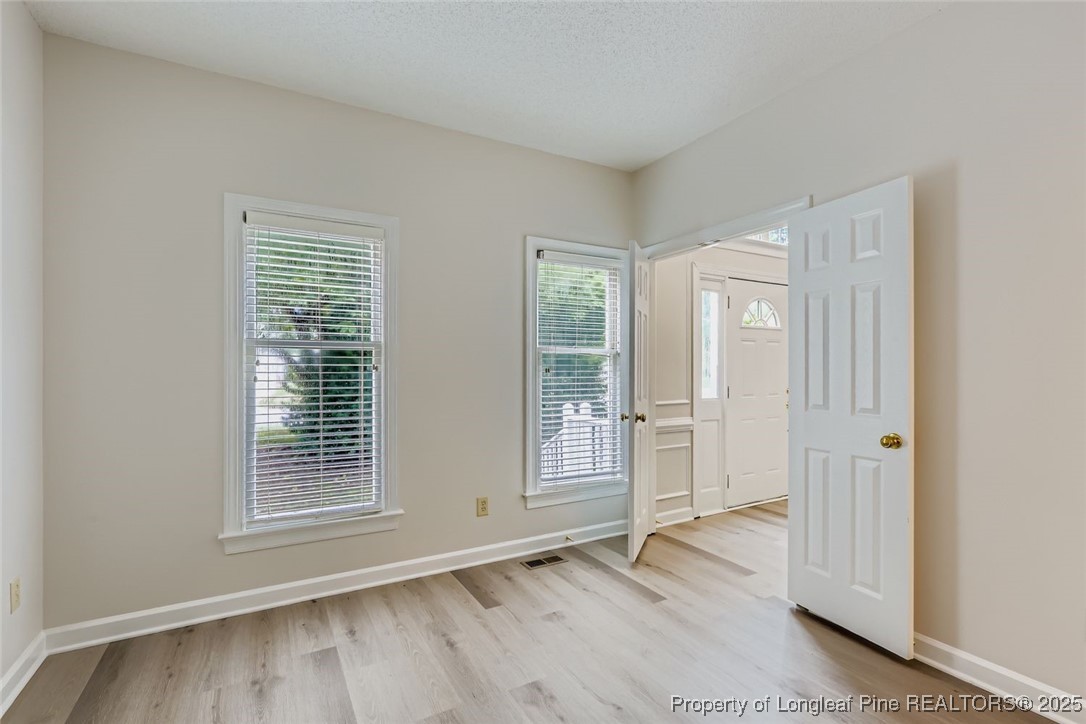 9012 Walking Stick Trail Raleigh, NC 27615 - Photo 14 of 28 an empty room with wooden floor and windows