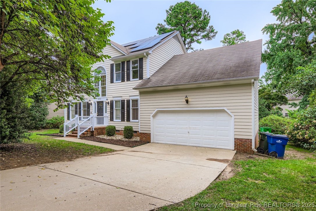 9012 Walking Stick Trail Raleigh, NC 27615 - Photo 2 of 28 a front view of a house with a garden and plants