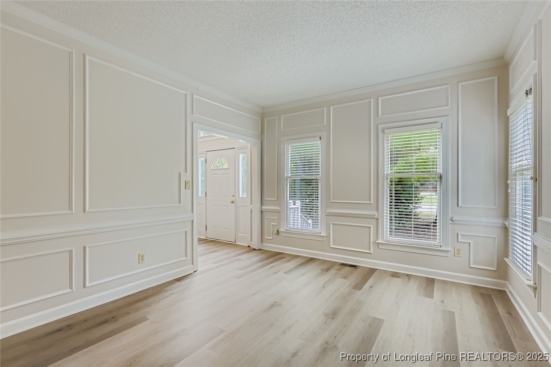 9012 Walking Stick Trail Raleigh, NC 27615 - Photo 5 of 28 a view of an empty room with a window and wooden floor