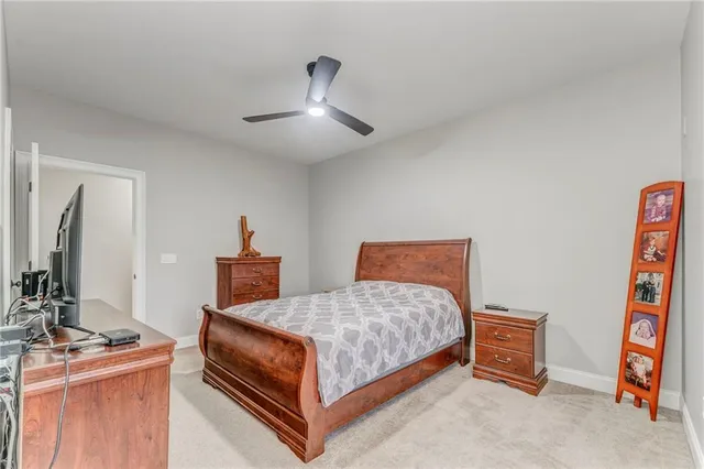 a kitchen with granite countertop a stove a sink a dining table and chairs
