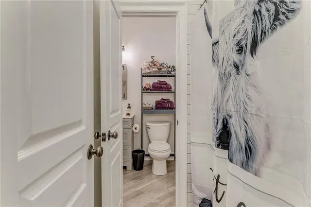 a kitchen with stainless steel appliances a dining table chairs refrigerator and microwave