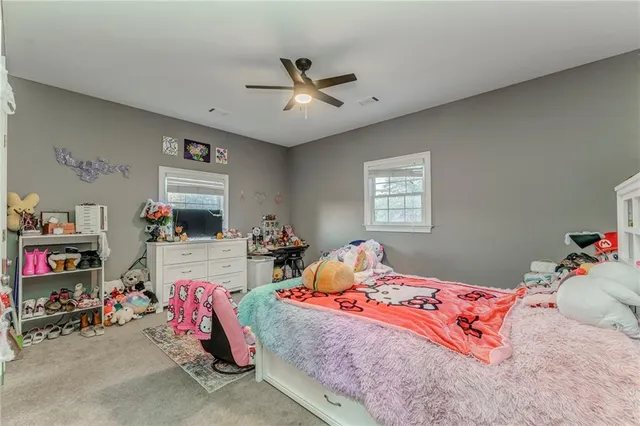 a living room with furniture a fireplace and a chandelier