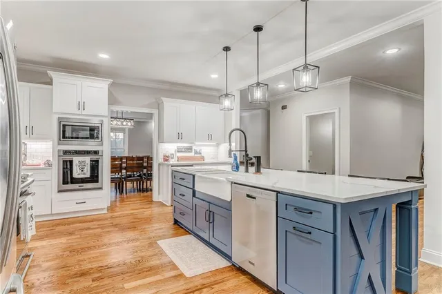 a bedroom with a large bed and a flat tv screen on dresser