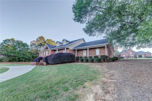 an aerial view of a house with a yard and a garage