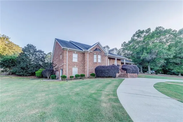 a view of house with a yard and entertaining space